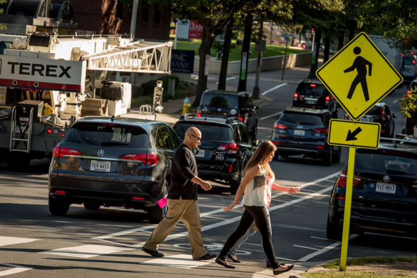 Two adults crossing the street in Arlington VA